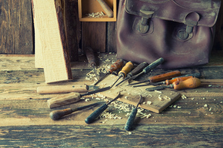 Chisels and carved piece of wood in traditional carpenter workshopの写真素材