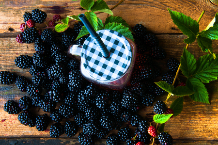 Delicious blackberry drink and fruits on wooden backgroundの写真素材