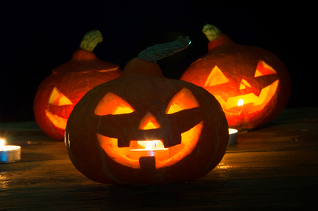 Scary halloween pumpkins on dark backgroundの写真素材