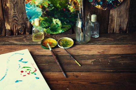 Palettes, brushes and canvas in an old painting workshopの写真素材