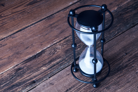 Hourglass on wooden background. Copyspaceの写真素材