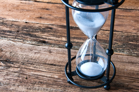 Hourglass on wooden background. Copyspaceの写真素材
