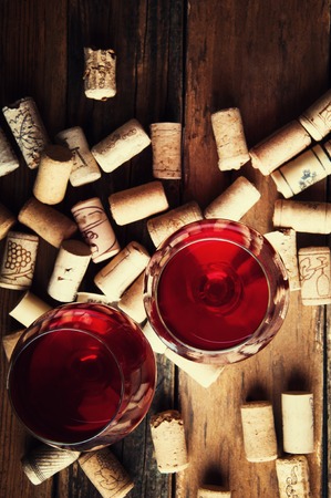Two glasses of red wine and corks. Copyspace. Top viewの写真素材