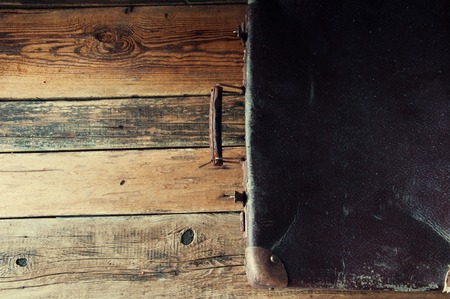 Vintage suitcase on wooden floor. Copyspace. Top viewの写真素材