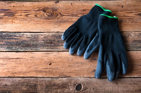Gardening gloves on wooden background. Copyspaceの写真素材