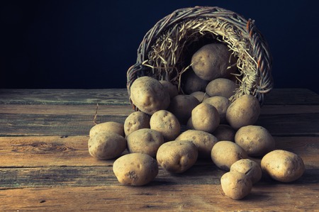 Potetoes on wooden tableの写真素材