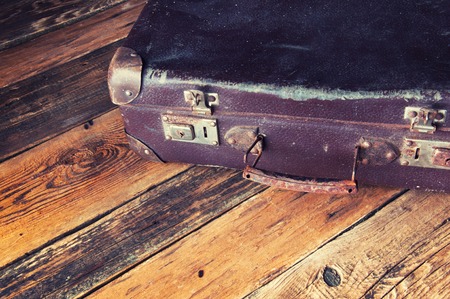 Vintage suitcase on wooden floor. Copyspace. Top viewの写真素材