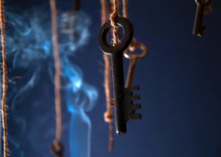 Keys hanging on a string. Smoke background. Selective focusの写真素材