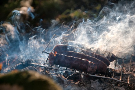 Grilling sausages on campingの写真素材