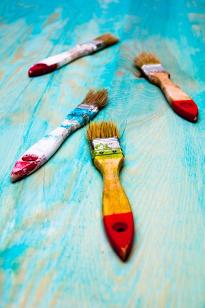 Painting brushes on blue wooden tableの写真素材