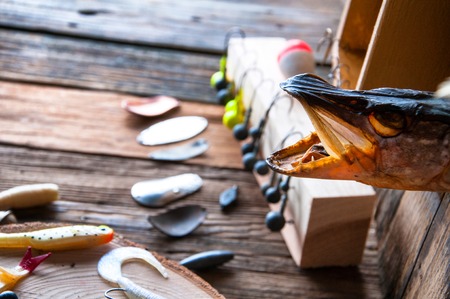 Fishing equipment on vintage wooden background