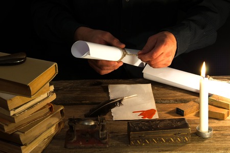 Man writing a letter with quill and sealing. Vintageの写真素材