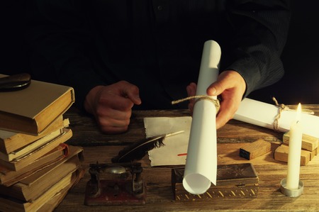 Man writing a letter with quill and sealing. Vintage