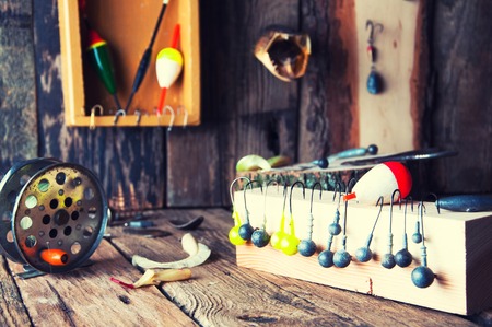 Fishing equipment on vintage wooden background. Selective focusの写真素材
