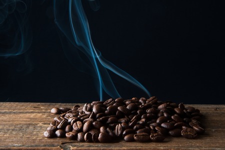 Smoke rising over roasted coffee beansの写真素材