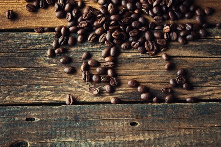 Coffee beans on vintage wooden background. Copyspaceの写真素材