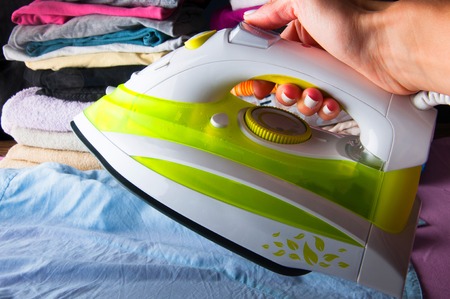 Ironing laundered clothes. Houseworkの写真素材
