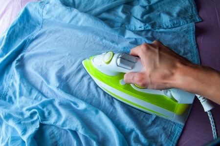 Ironing laundered clothes. Houseworkの写真素材