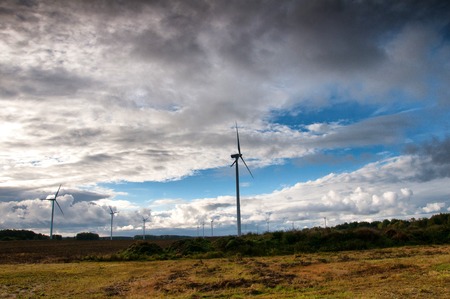 Wind turbine on autumnal backgroundの写真素材