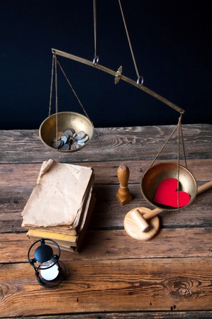 Old fashioned scale showing the advantage of love over money