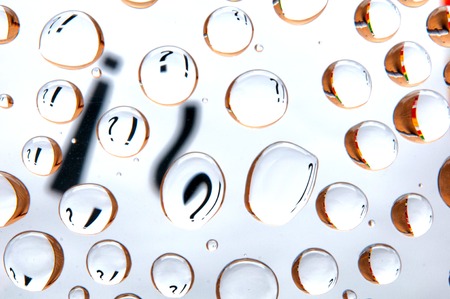 Question mark and exclamation mark behind water drops. Abstract backgroundの写真素材