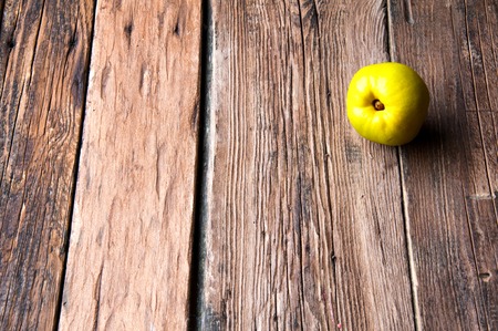 Green apple on wooden background. Copyspaceの写真素材