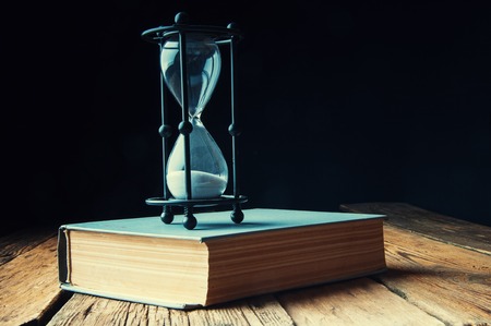 Hourglass on an old books. Copyspace