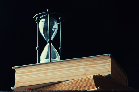 Hourglass on an old books. Copyspace