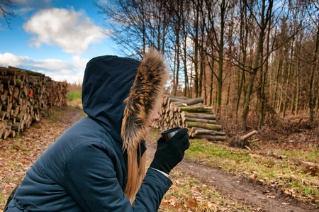 Girl drinking hot cocoa drink from the thermos