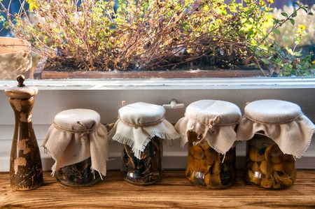 Jars with pickled mushrooms in kitchenの写真素材