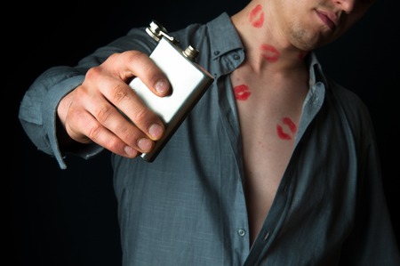 Drunk man with many lipstick stampsの写真素材