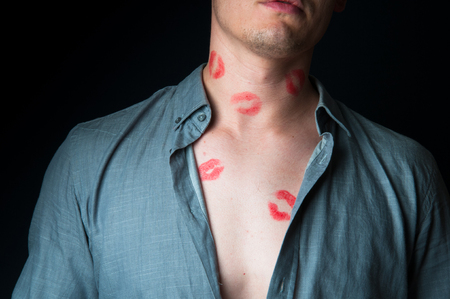 Man with many lipstick stampsの写真素材