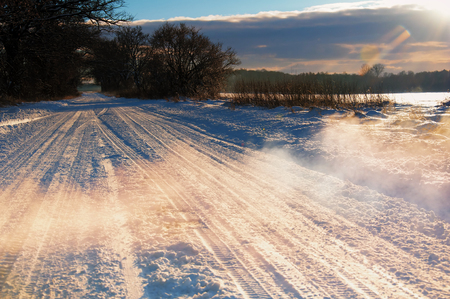 Country road covered with snow in winterの写真素材