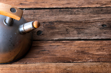 Chrome kettle on wooden table, copyspaceの写真素材