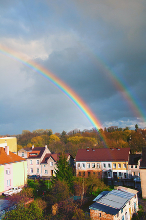 Rainbow over the city in autumnの写真素材
