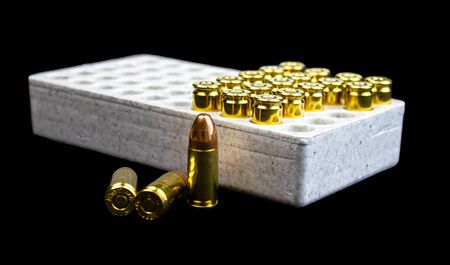 Some 9mm bullets isolated in a white box.の写真素材