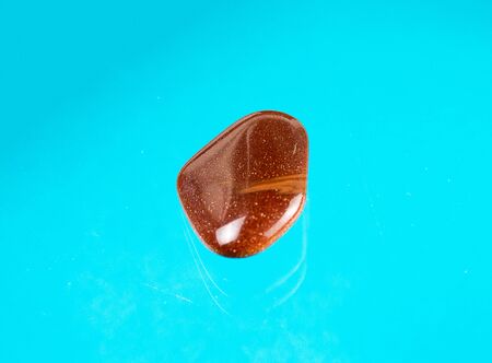 A redbrown aventurine glass with a sparkling red surface.の写真素材