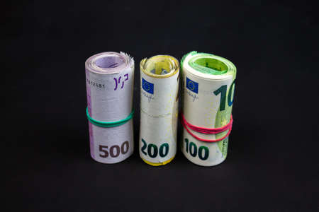 Standing and rolled euro notes. 100, 200 and 500 banknotes. A total of several thousand euros.