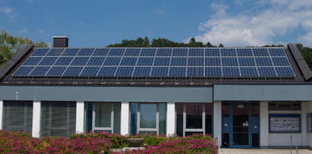 A three-row photovoltaic system built on an office building.の写真素材