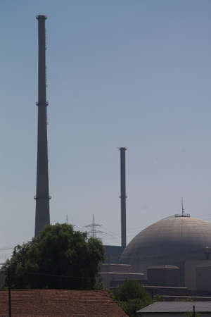 The reactor dome of a nuclear power plant. And behind it two chimneys.の写真素材