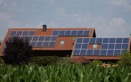 A photovoltaic system on a residential building. Every possible area is equipped with panels here.の写真素材