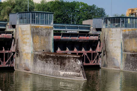 A floodgate of a hydropower plant with a machine house.の写真素材