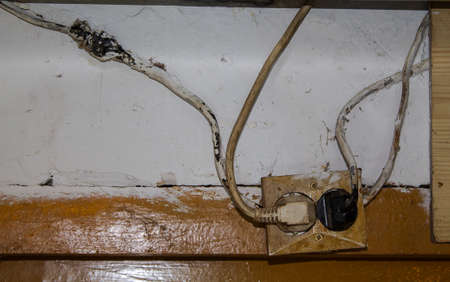 Adventurous, life-threatening wiring of sockets simply painted over.の写真素材