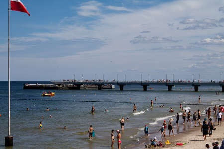 People on the Polish Baltic Sea beach here in Kolobrzeg, Kolberg Summer 2020.の写真素材