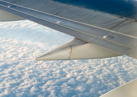 View from a plane to the wing ans clouds