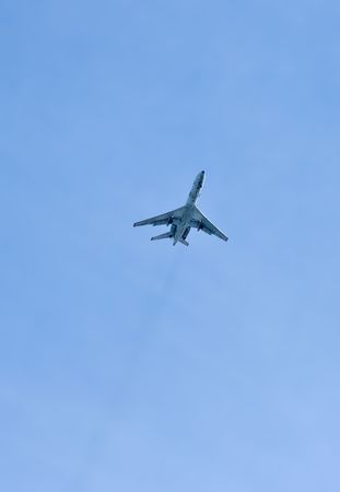 a plane flies in a clear blue sky 