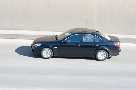 black car in motion with blurred background