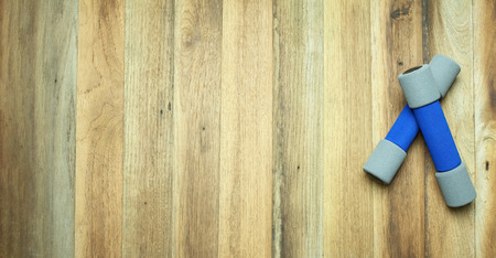 A pairs of dumbbell on wooden backgroundの写真素材
