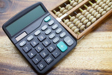 Abacus,calculator with wooden table backgroundの写真素材
