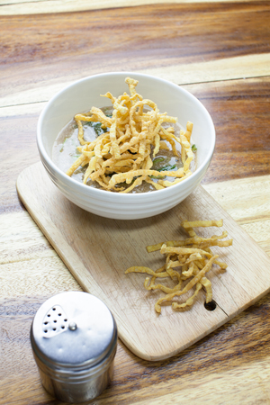 Fried noodle in Gravy on wooden backgroundの写真素材